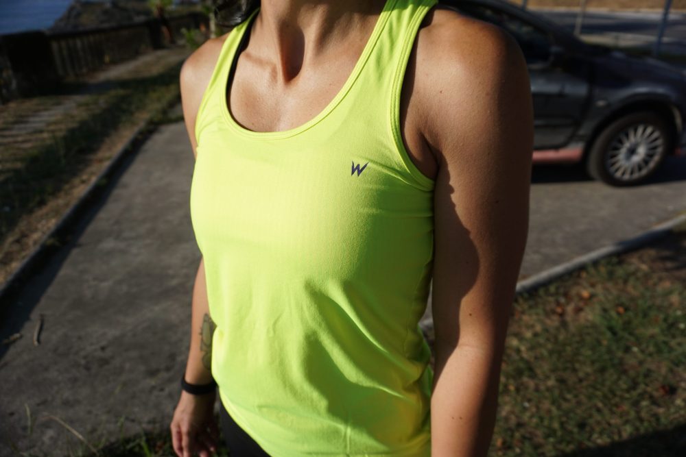 detalle frontal logotipo camiseta técnica mujer diseño Vento en color flúor amarillo